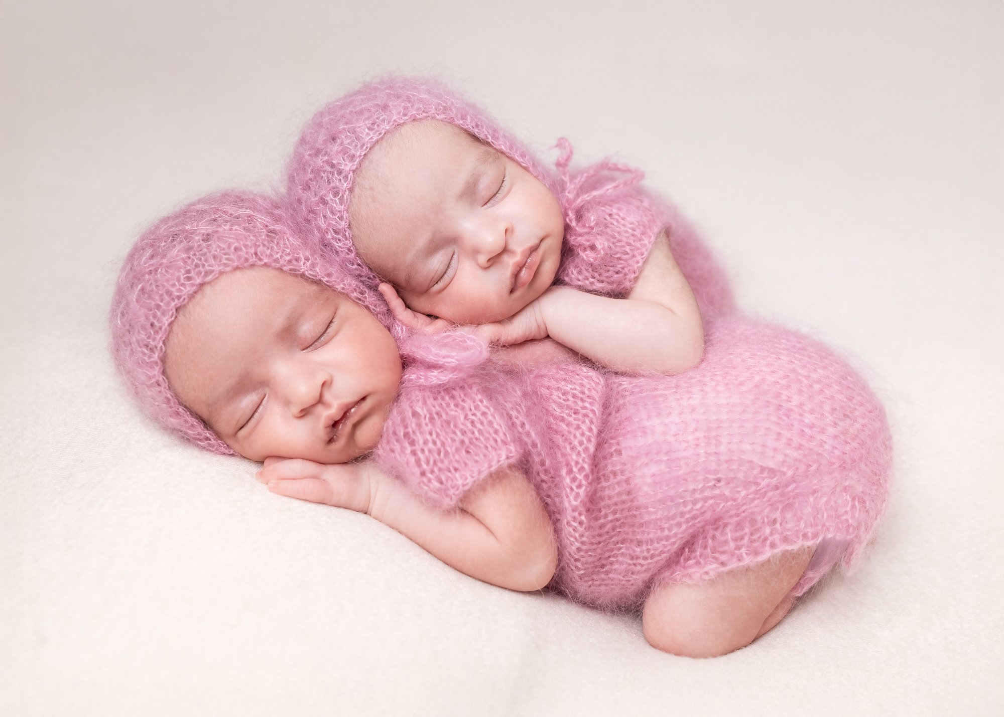 Twin newborns in matching pink mohair bonnets and knit outfits — IDTPhoto Chicagoland newborn photography