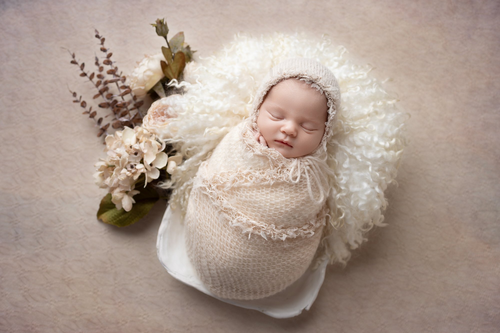 Newborn in cream lace wrap and bonnet with dried botanical arrangement — IDTPhoto Chicagoland newborn photographer